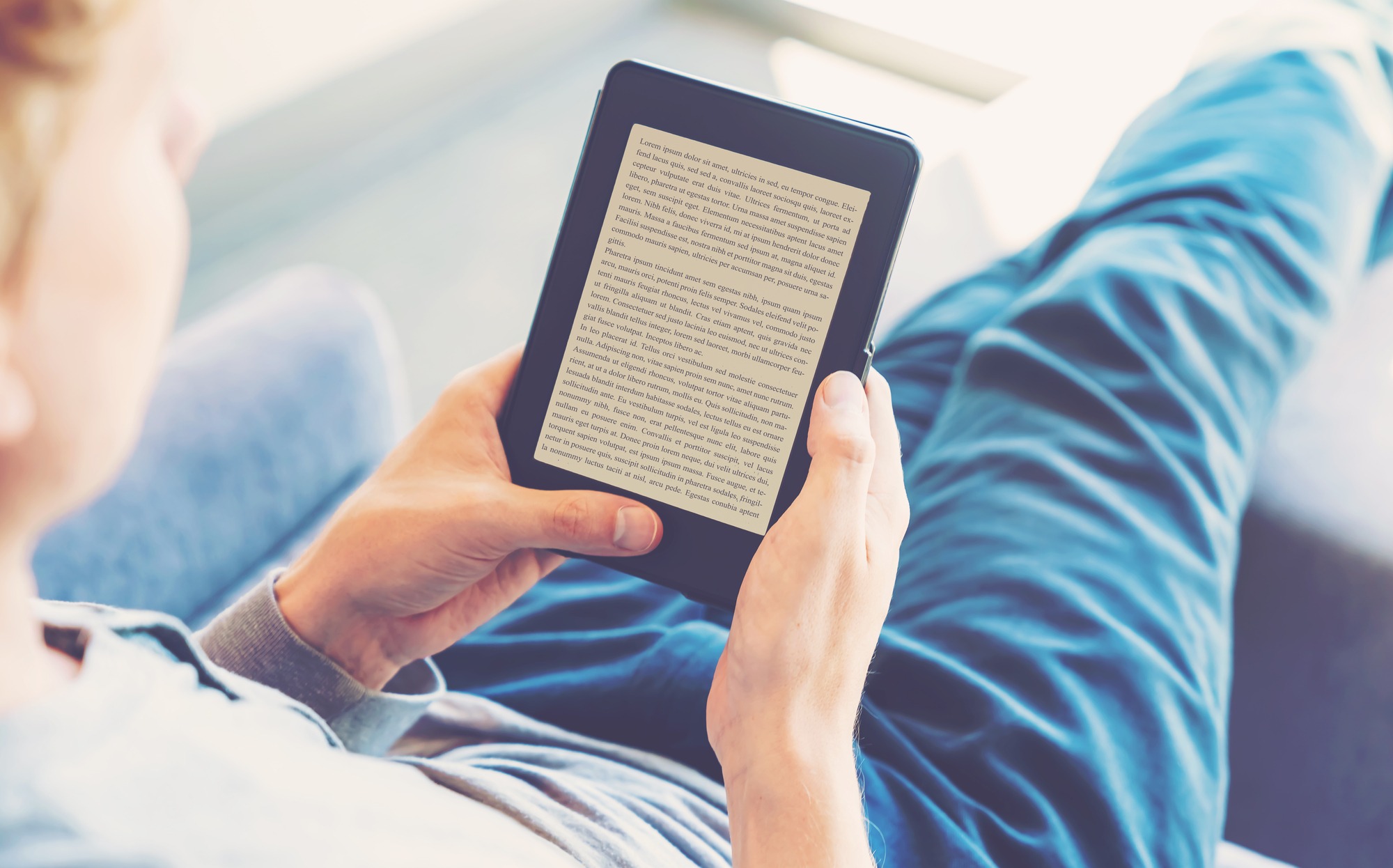 Man reading a story on digital tablet device.
